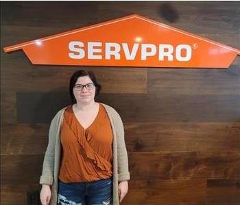 female posing servpro sign black background