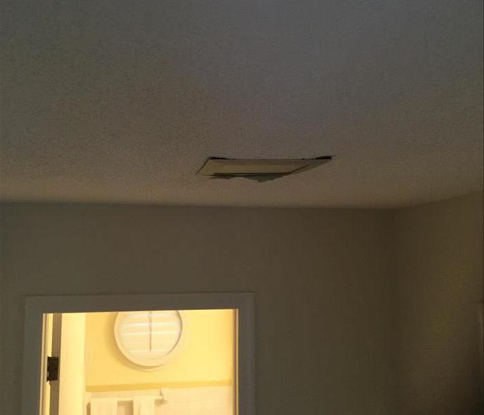 water damaged ceiling by light fixture