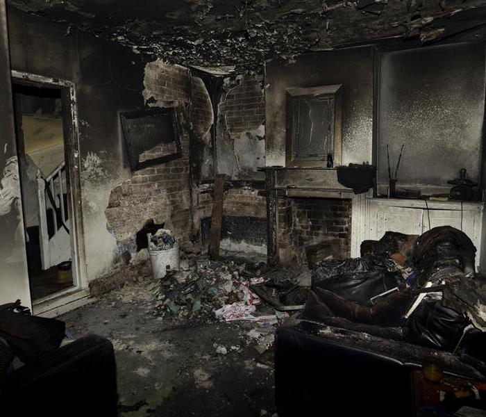 Fire and soot damage in a living room.